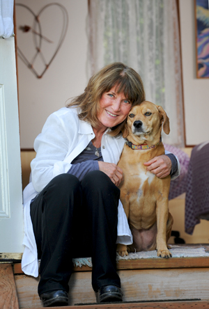 Dhyana Moyer, licensed Strain Counterstrain practitioner, and her dog, Abby